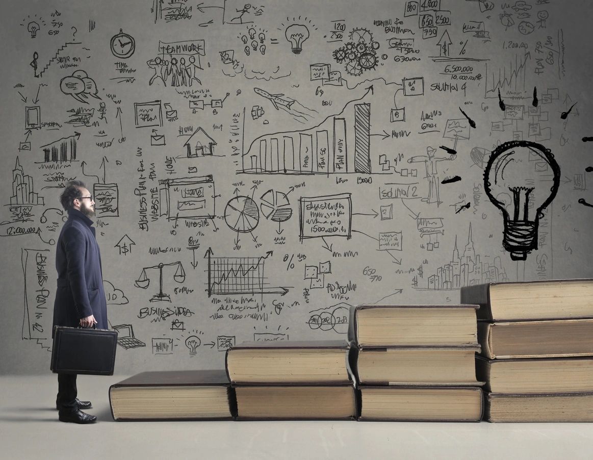 A man standing in front of some books